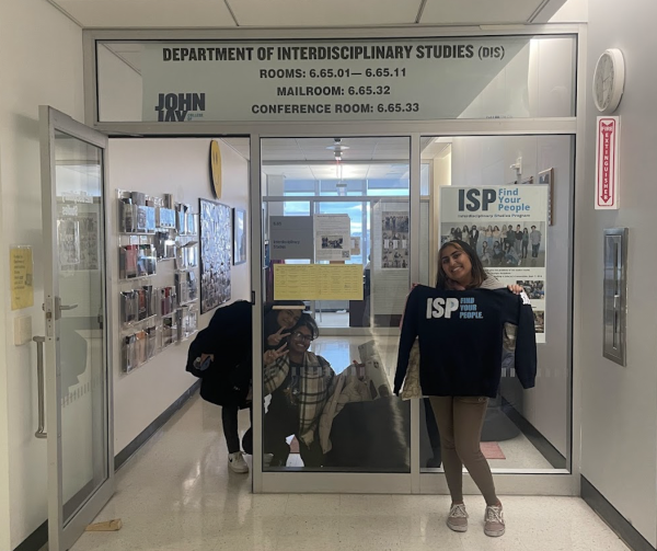 ISP students in front of the department with program merch.